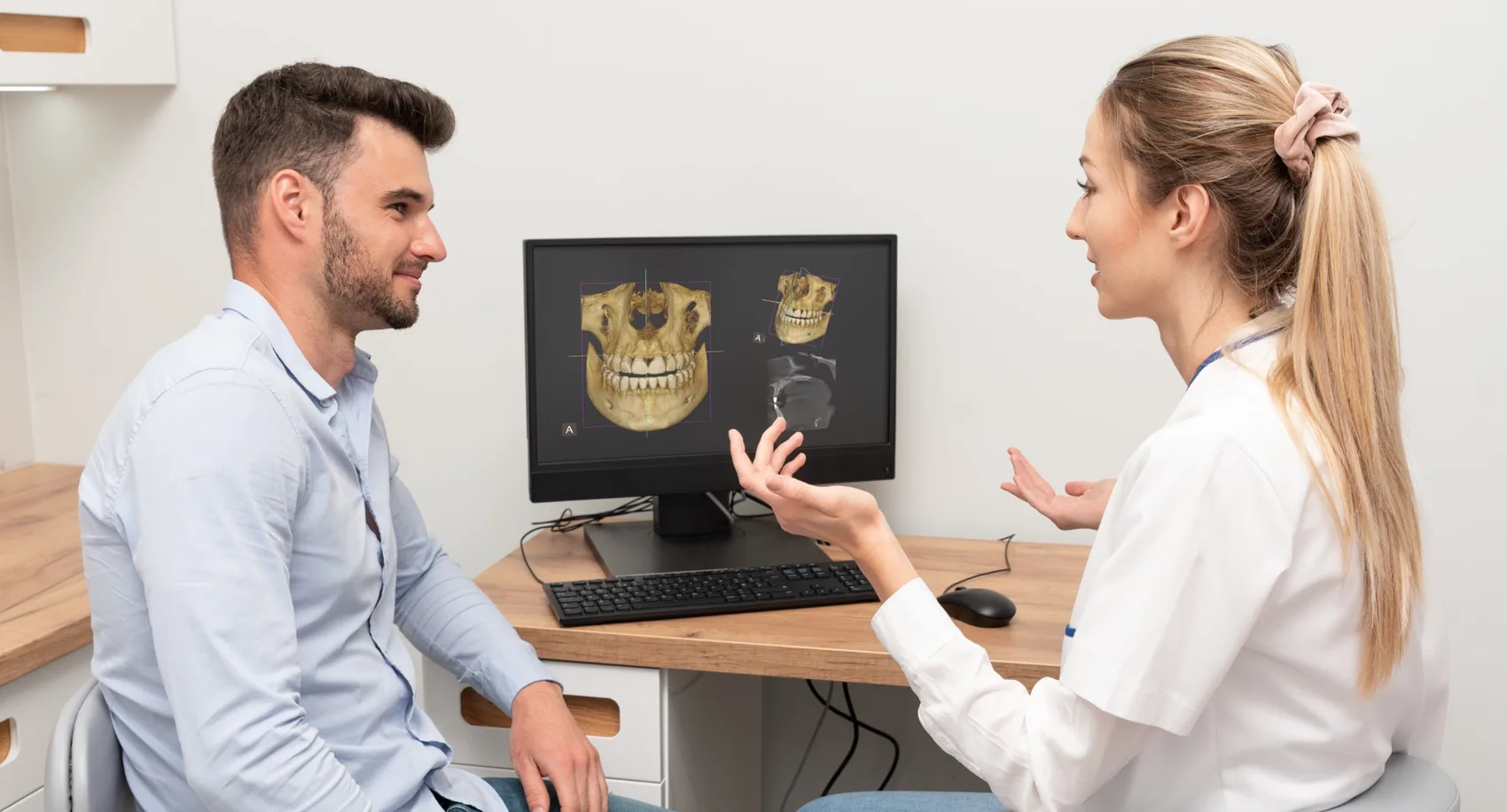 Profesional revisando imágenes dentales con un paciente